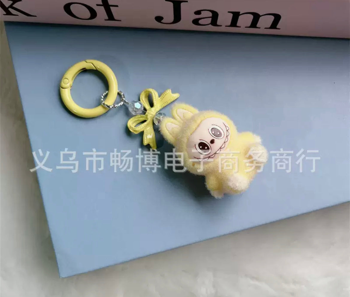 fuzzy flock sitting labubu with keychain and bow colored ,random mix