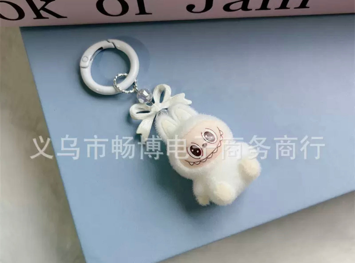 fuzzy flock sitting  labubu with keychain and bow colored ,random mix