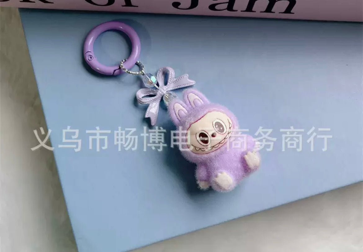 fuzzy flock sitting  labubu with keychain and bow colored ,random mix