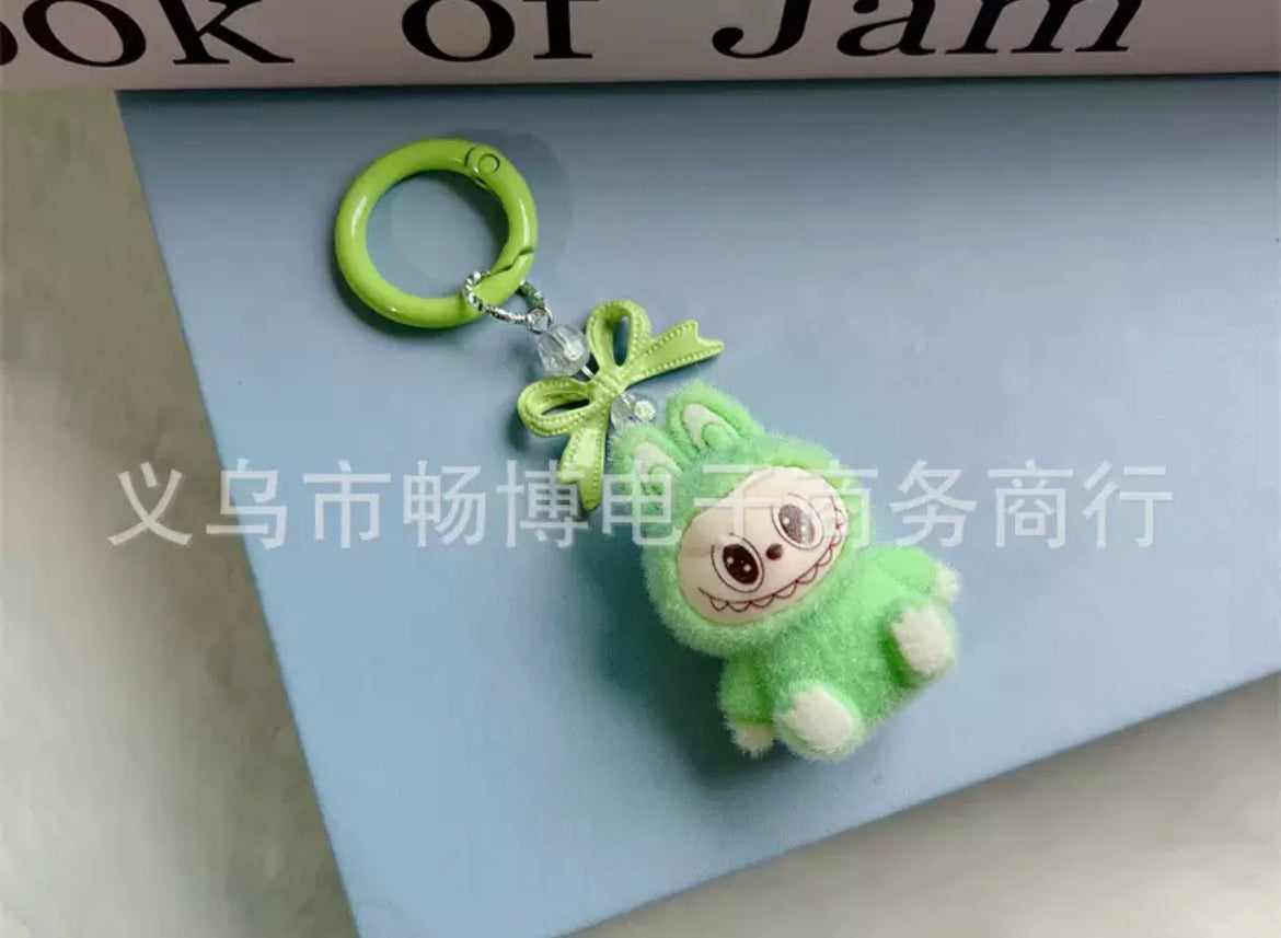 fuzzy flock sitting  labubu with keychain and bow colored ,random mix