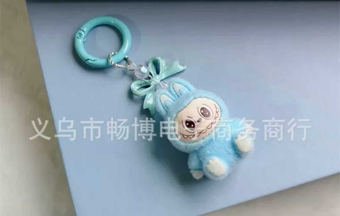 fuzzy flock sitting  labubu with keychain and bow colored ,random mix