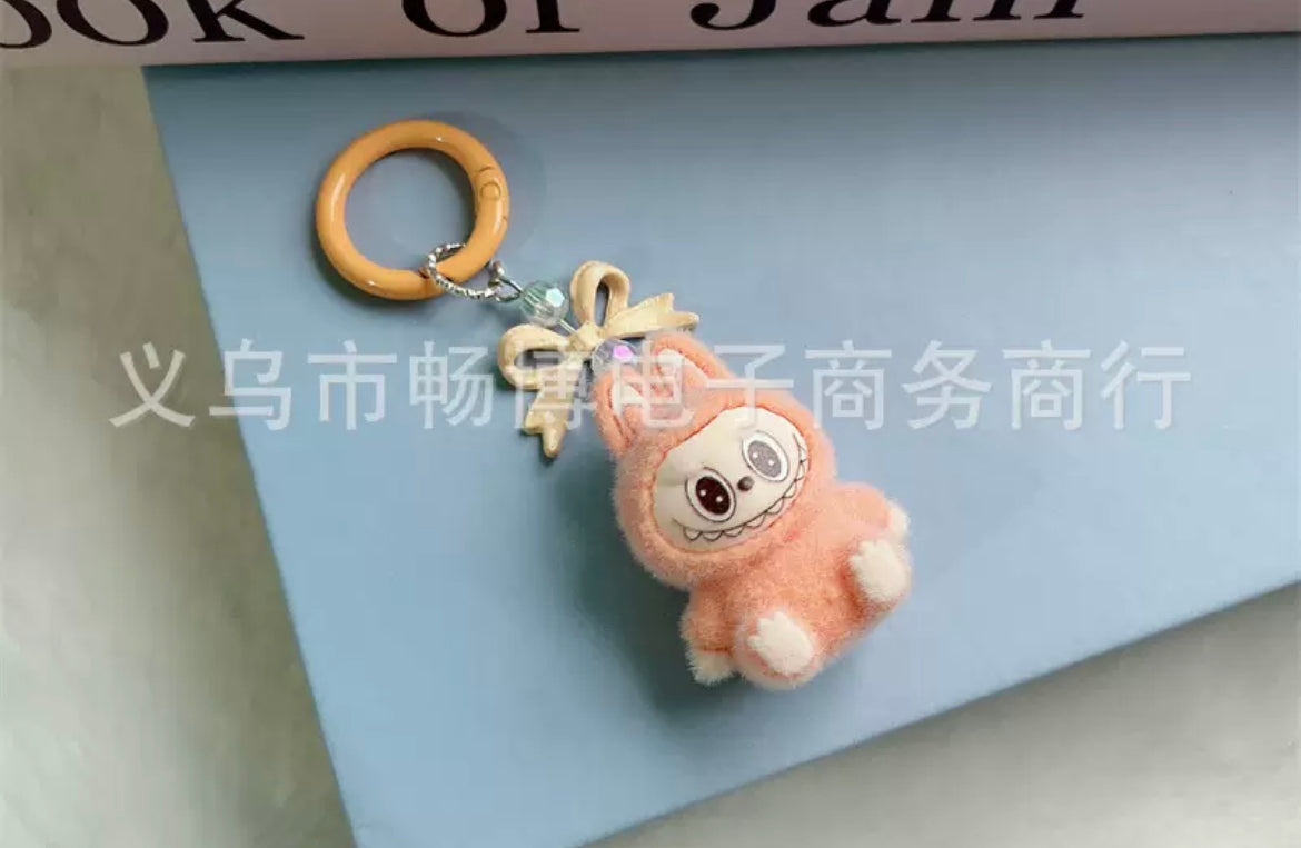 fuzzy flock sitting  labubu with keychain and bow colored ,random mix