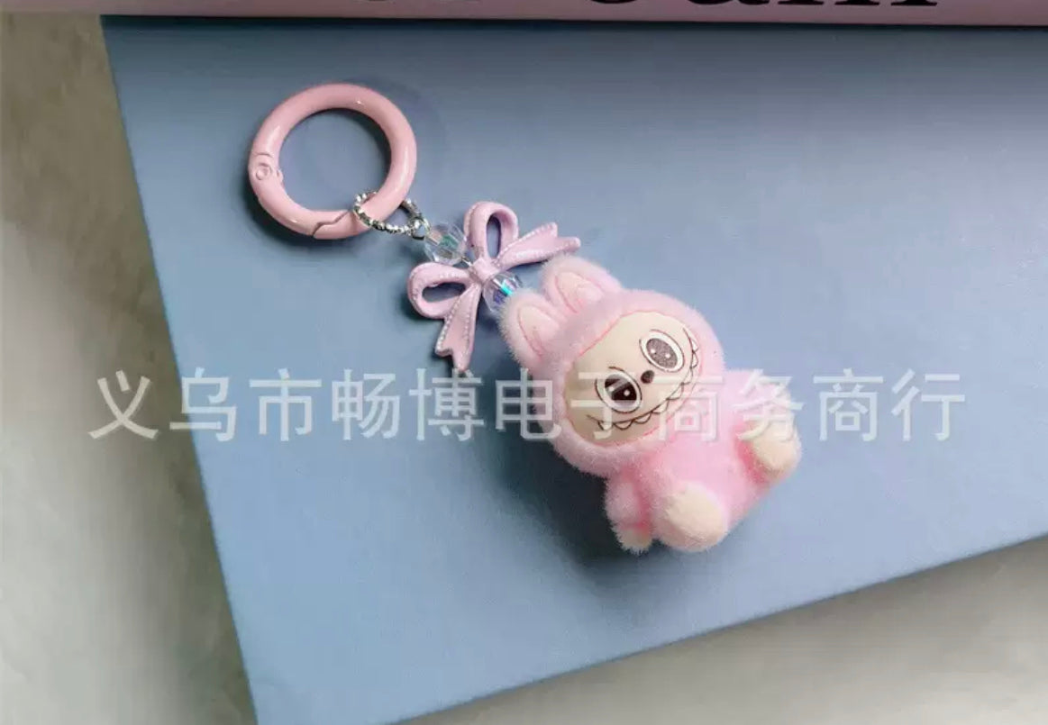 fuzzy flock sitting  labubu with keychain and bow colored ,random mix