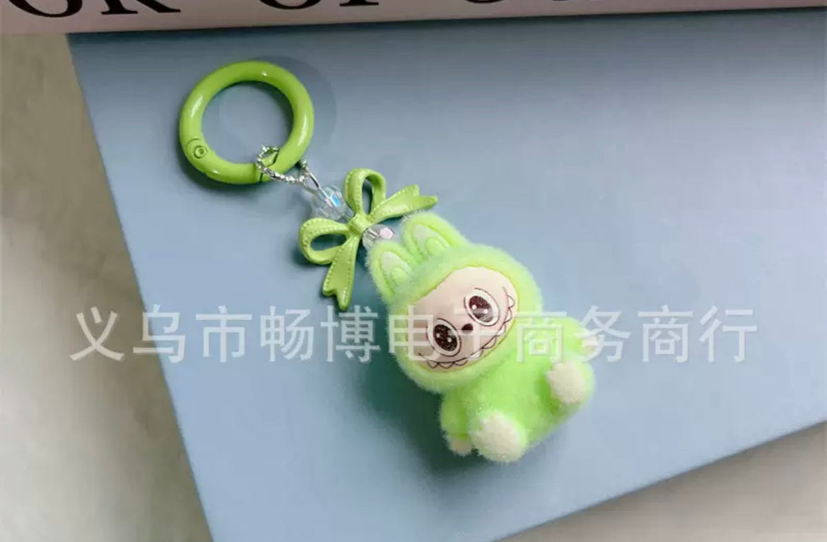 fuzzy flock sitting  labubu with keychain and bow colored ,random mix