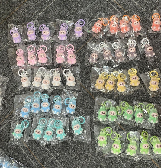 fuzzy flock sitting  labubu with keychain and bow colored ,random mix